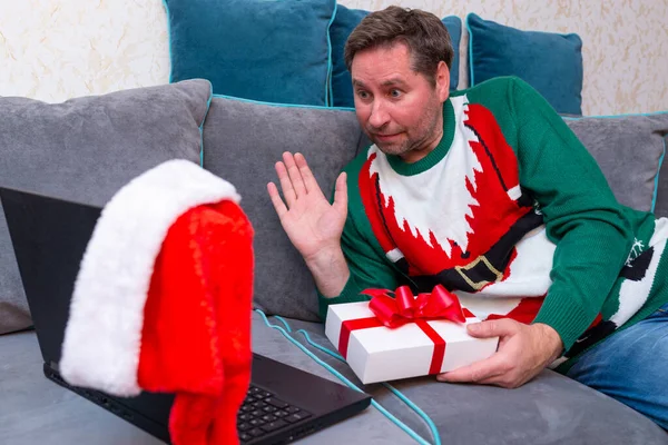 Mężczyzna Praktycznie Wymieniając Prezenty Świąteczne Mając Wideo Połączenie Przez Laptop — Zdjęcie stockowe