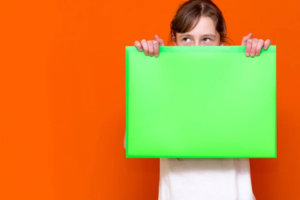 Mysterious Caucasian Young Girl Hiding Bright Green Folder Banner Advertisement — Stock Photo, Image