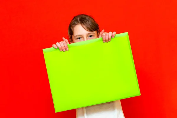 Young Caucasian Teenager Girl Holding Blank Paper Sheet Red Background — Stock Photo, Image