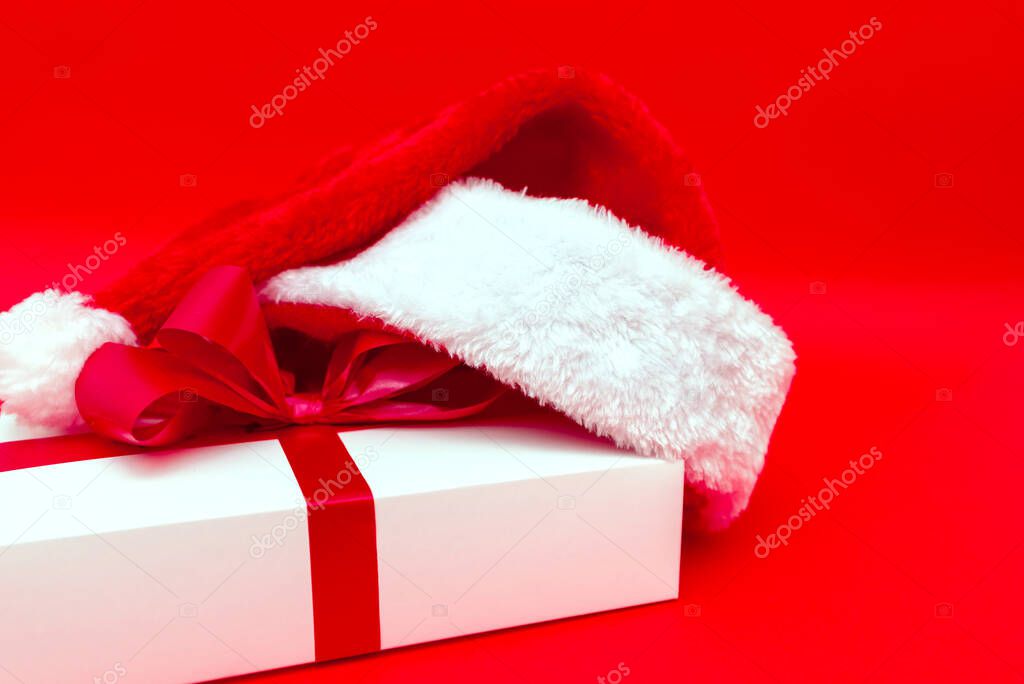 Christmas present with santa hat close up flat lay