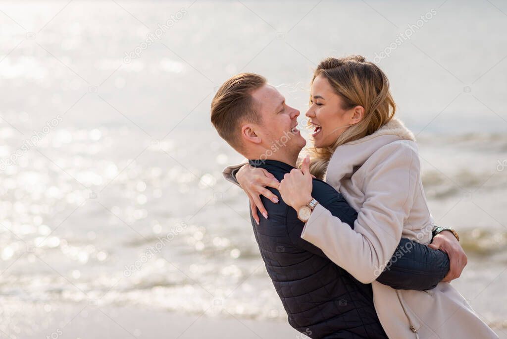 Young couple enjoying on a sand and enjoying each other.Summer,spring,autumn vacation.