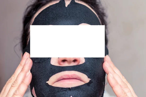 Young Woman Apply Black Cosmetic Fabric Facial Mask Home Face — Stock Photo, Image