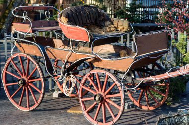 Eski At Arabası açık hava kafede akşam vakti şehir dışında çekiliyor. Araba çelenk ampulleriyle dolu..
