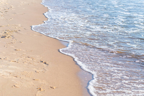 Soft wave of the sea on the sandy beach.Soft focus,blurred image.Copy space.
