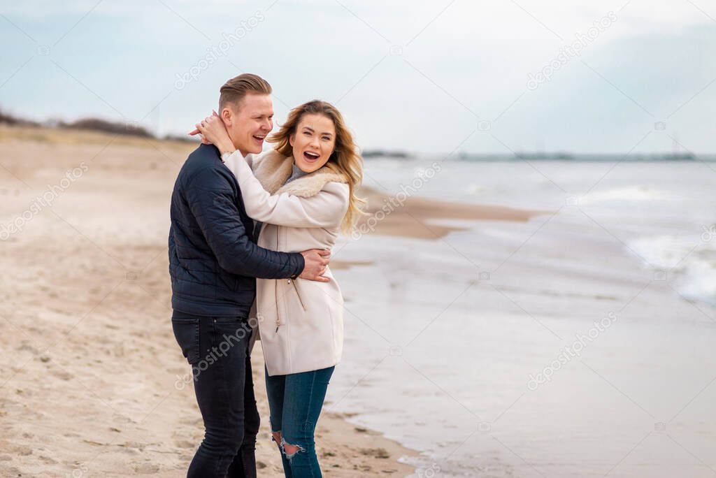 Young couple enjoying on a coast and enjoying each other.Summer,spring,autumn vacation.