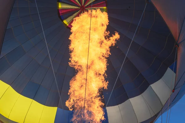 Hot air balloon with flame. Closeup.hot air balloon as it takes you on an adventure over the earth.Close-up of hot air balloon burner at golden hour,outdoors shot.