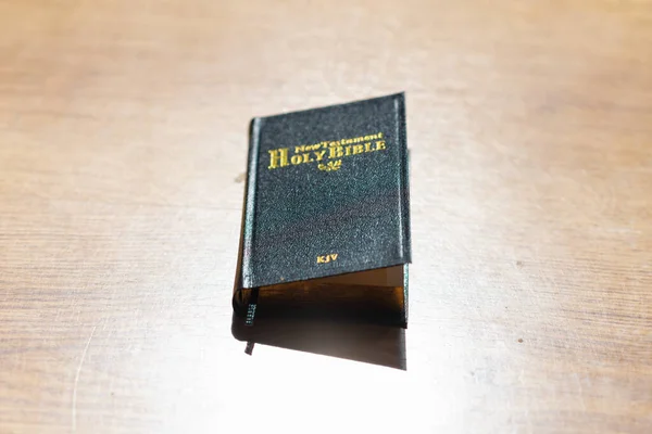 Bible in the light wooden background. The Holy Bible.The Old Holly Bible closed.Black holly Bible on a table.