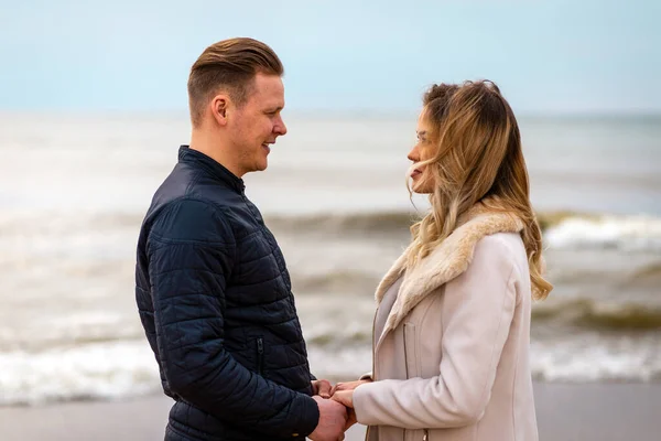 Young couple enjoying on a coast and enjoying each other.Summer,spring,autumn vacation.