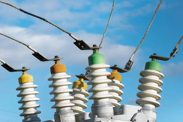 High voltage electric generator insulators.Detail of high voltage circuit breaker in a power substation.high voltage circuit breaker in a power substation on a summer cloudy day.Closeup.Copy space.