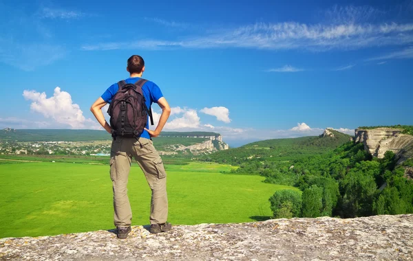 Man tourist in mountain read the map. Man on top of mountain. — Stock Photo, Image