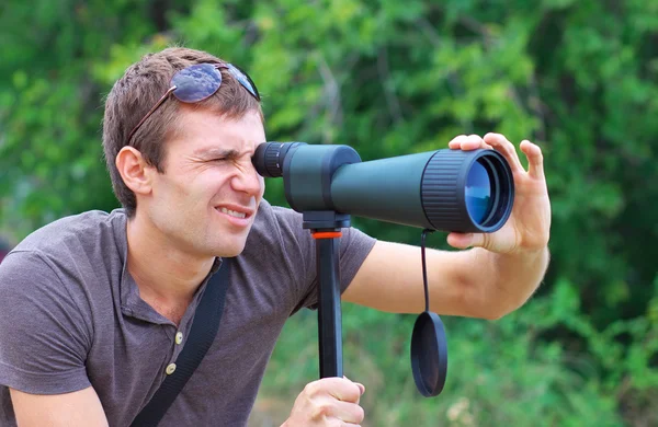 Man who is watching in spotting scope. — Stock Photo, Image