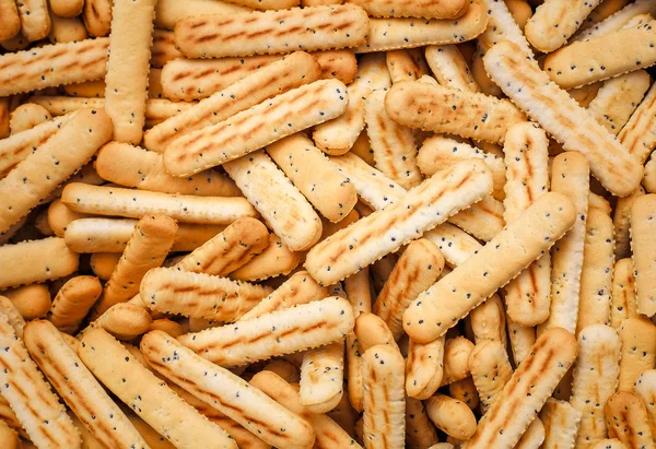 Хлеб палочки с маком семян в качестве фона — стоковое фото