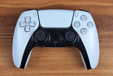 Moskova - 19 Kasım 2020: Beyaz Sony PS5 DualSense kablosuz kontrolörleri PlayStation 5 için ahşap arka planda.