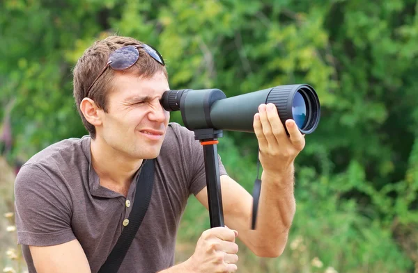 Man who is watching in spotting scope. — Stock Photo, Image