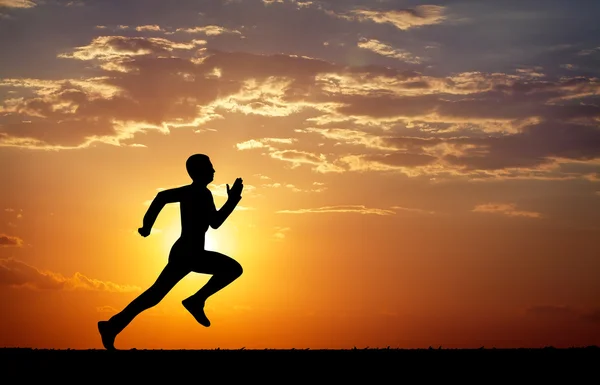 Silhouette of running man against the colorful sky — Stock Photo, Image