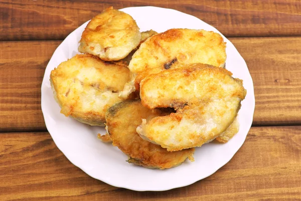 Cooked, fried pieces of fish on a white plate — Stock Photo, Image