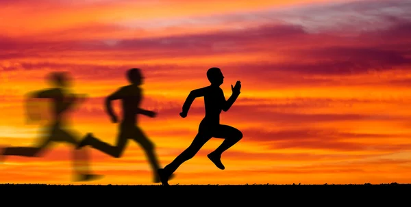 Silhouette of running man against the colorful sky. — Stock Photo, Image