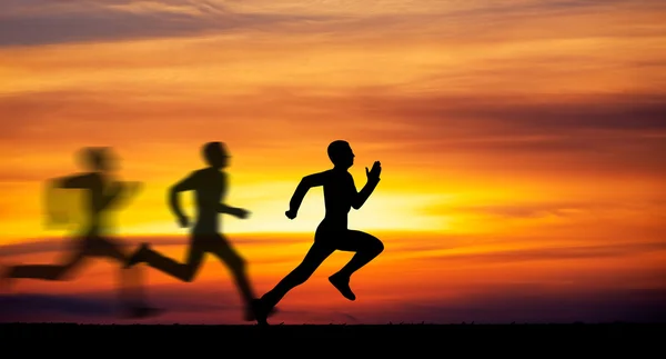 Silhouette of running man against the colorful sky. — Stock Photo, Image