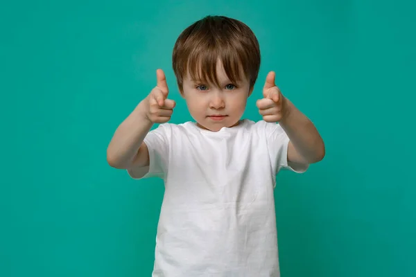Beautiful boy of five years old in a white T-shirt shows hand gestures and emotions on an isolated Copy space background — Stock Photo, Image
