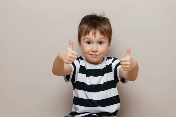 Portrait of a toddler in a striped t-shirt shows class — Stock Photo, Image