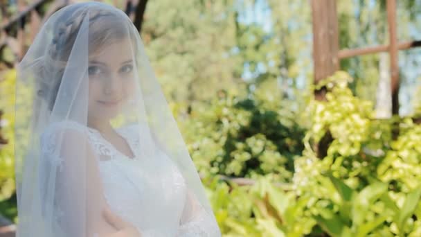 Hermosa novia pose a fotógrafo al aire libre — Vídeo de stock