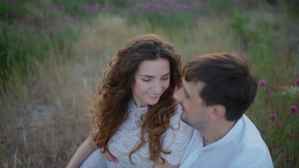 Young couple sit in the field — Stock Video