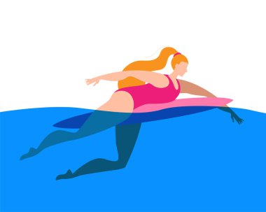 Sörfçü kız sörf tahtasında yüzüyor..