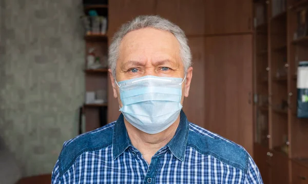 A man in a medical mask at home. Covid-19 Quarantine