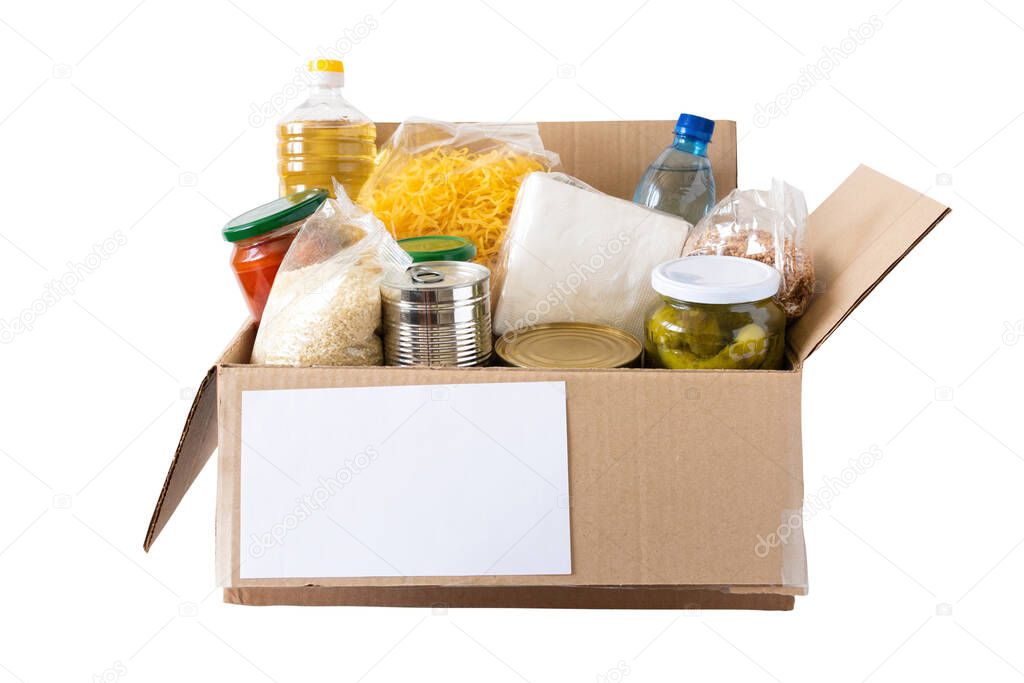 Cardboard box with butter, canned food, cereals and pasta. A donation box with various food items.