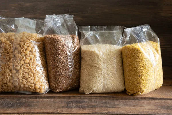 Koyu ahşap arka planda tahıl paketleri. Yiyecek stoku kavramı