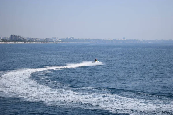 Young man riding on the jet ski in Mediterranean Sea, Antalya district, Turkey. Man riding on water scooter in the sea.