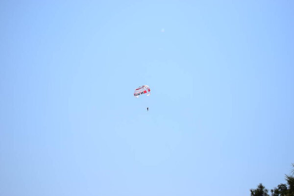 Turkey paraglider in the sky. Skydiver enjoys a blue sky over the sea.