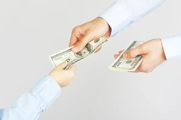 Man's hand give money american hundred dollar bills to boy hand — Stock Photo, Image