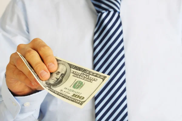 Men's hand holding money american hundred dollar bills. Hand of businessman offering money. — Stock Photo, Image