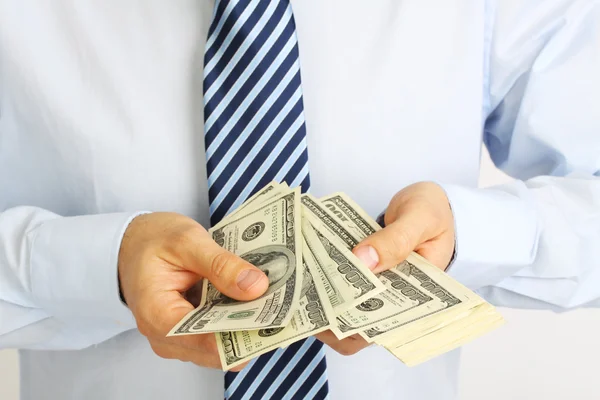 Men's hand holding money american hundred dollar bills. Hand of businessman offering money. Businessman counting money. — Stock Photo, Image