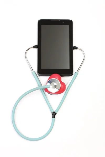 Stéthoscope cardiaque rouge à impulsions d "écoute sur tablette - sur fond blanc — Photo