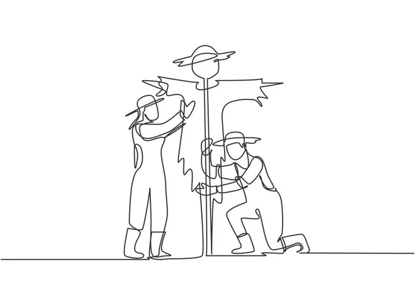 Single One Line Drawing Young Couple Farmer Installing Scarecrow Ward — Stock Vector