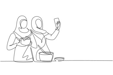 Continuous one line drawing two Arab woman taking selfie or making video call using her smartphone while cooking fresh salad. Healthy food concept. Single line draw design vector graphic illustration