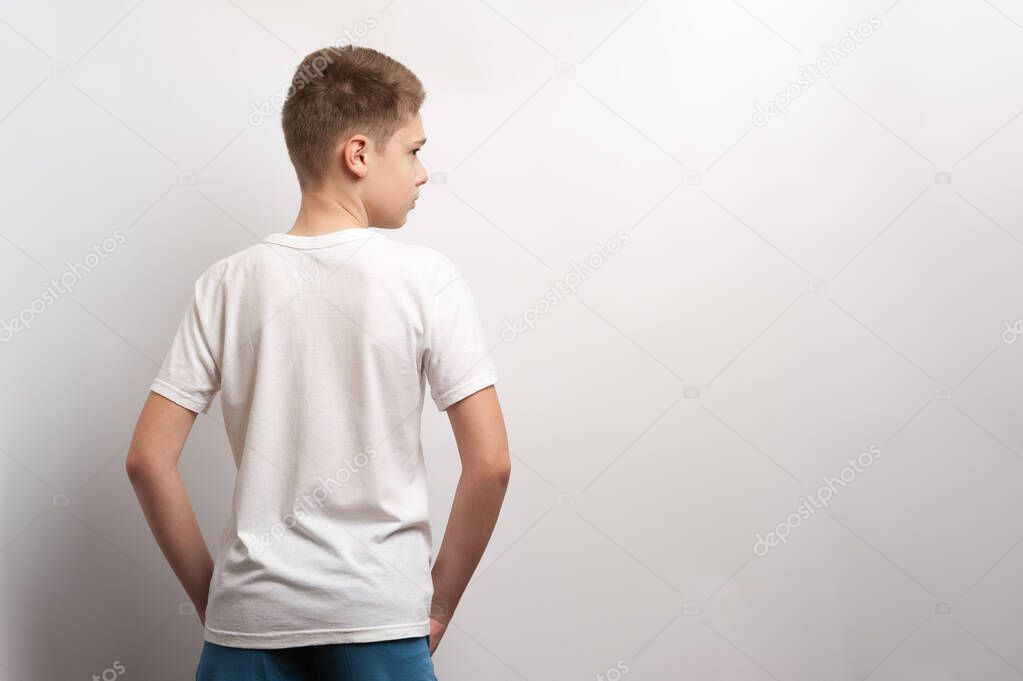 A boy model posing in a white t-shirt