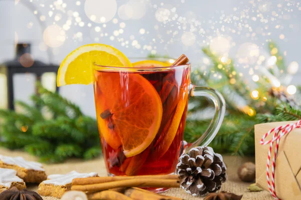 A glass of hot wine, mulled wine in a New Year\'s setting with bokeh in the background. Christmas, winter hot drink.