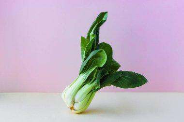İzometrik bej ve pembe arka planda organik Çin lahanası pak choi. Biyolojik sebzeler, metin için yer.