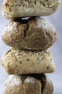 Close-up of various types of breads, buns made from plain and whole grain flour. Bakery, cafe, bread baking. vertical photo. Ideal for advertising