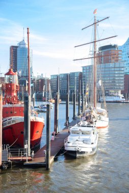 Port of the German city of Hamburg. Ships moored at the pier. Vertical photo
