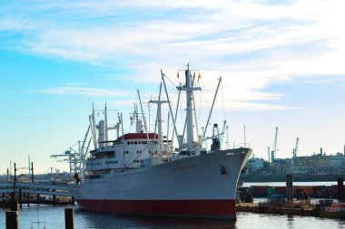 A ship, a fishing vessel, and a cargo liner are in the port. Port in the German city of Hamburg. Germany, Hamburg - January 17, 2020