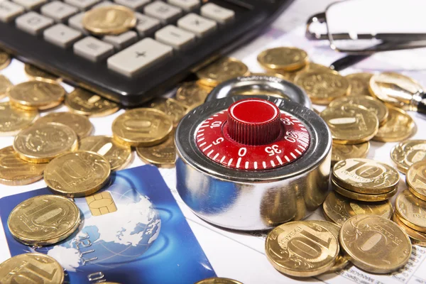 Business composition of the padlock on coins — Stock Photo, Image