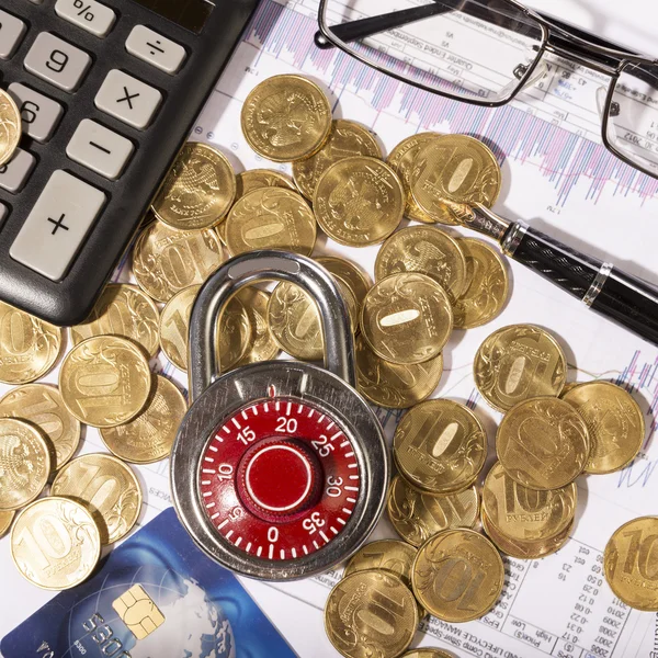 Business composition of the padlock on coins — Stock Photo, Image