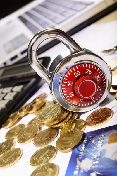 Business composition of the padlock on coins — Stock Photo, Image