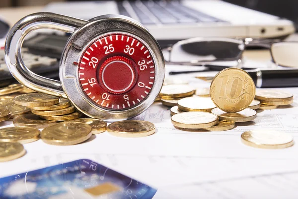 Business composition of the padlock on coins — Stock Photo, Image