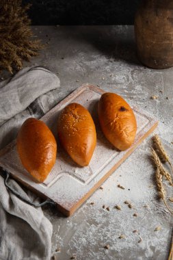 Tahtada ve arka planda üç kek.