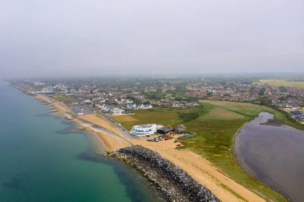 Aerial drone photo of the Bournemouth south beach on a very cloudy foggy day showing low level clouds by the ocean